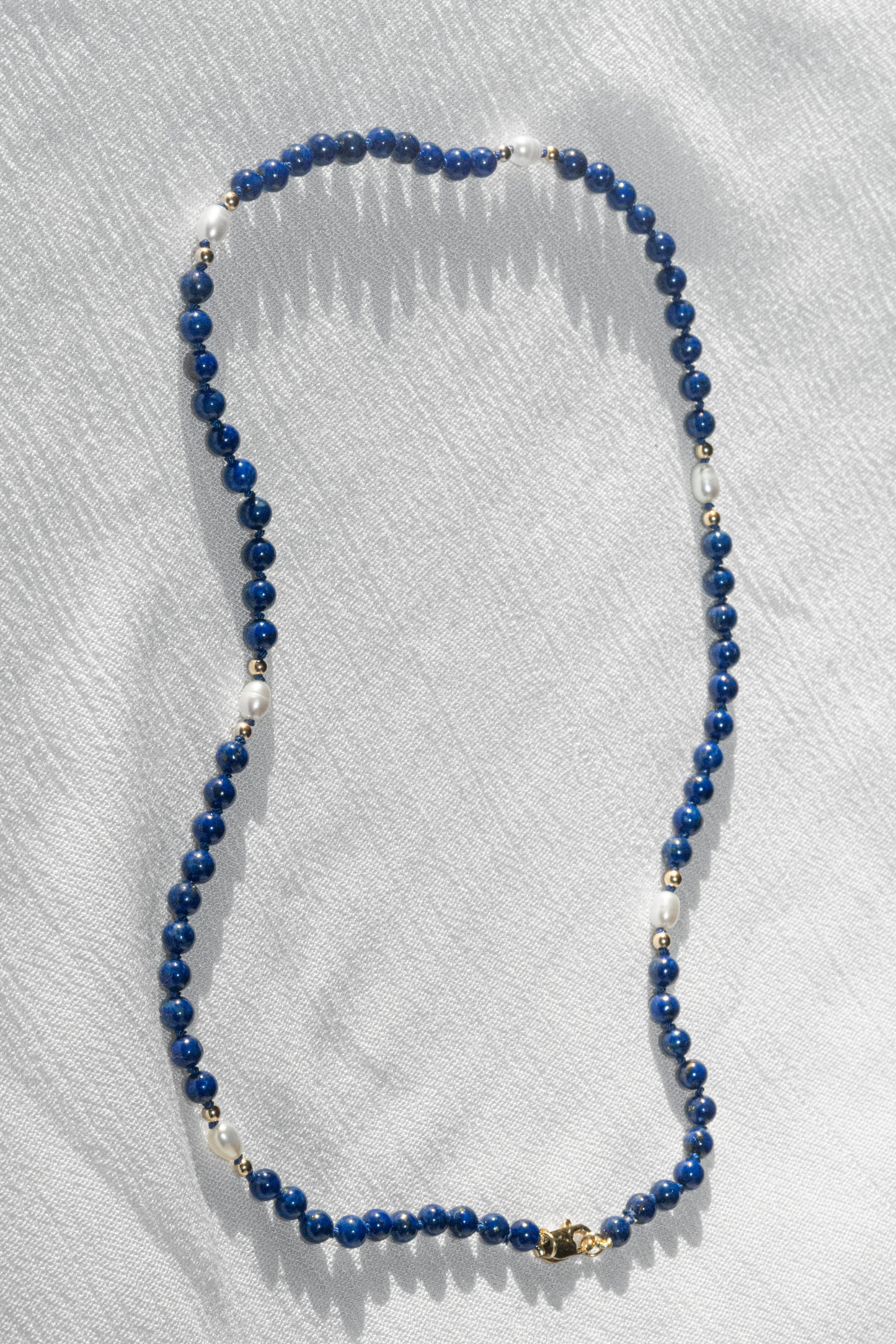 SJG Midnight Necklace with a 14K Yellow Gold Clasp at 16" with Lapis Lazuli, Rice Pearls and Gold Beads