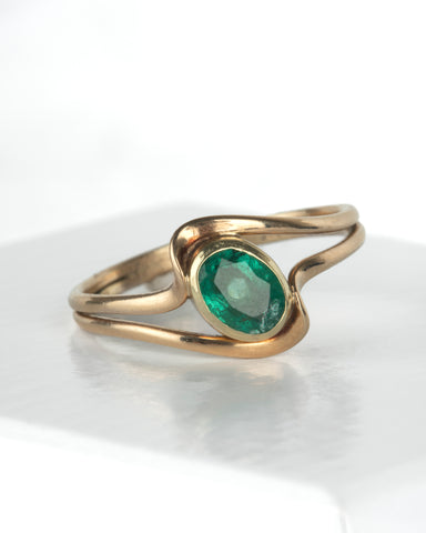 Oval Emerald Bezel Set Bypass Ring in 14K Yellow Gold at a Size 8